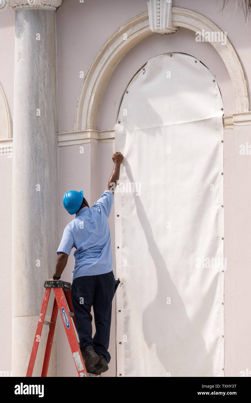 Workers Attach Hurricane Cloth To Windows On The Charleston City