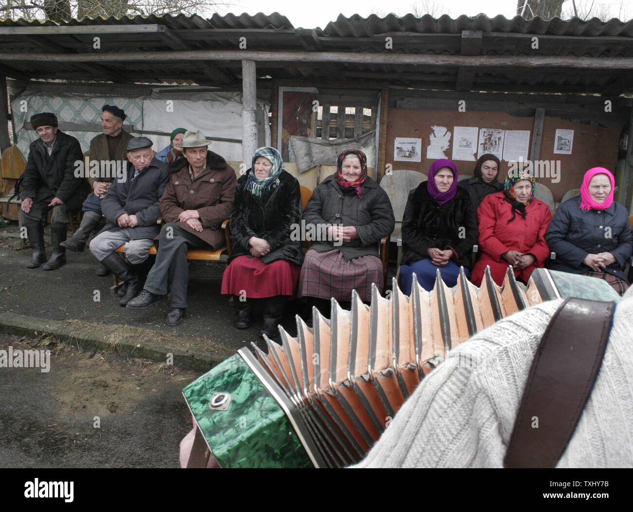 Elderly Ukrainian illegal settlers in the exclusion zone around the closed Chernobyl nuclear power plant attend an open air concert in the Ilinci village, April 5, 2006. At the end of April, Ukraine will mark the 20th anniversary of the Chernobyl nuclear disaster, when the fourth reactor at the Chernobyl plant exploded, spreading a radioactive cloud across the former Soviet Union. Thousands of people died from the effects of the radiation and millions more in the region and across Europe have suffered health problems. (UPI Photo/Sergey Starostenko) Stock Photo