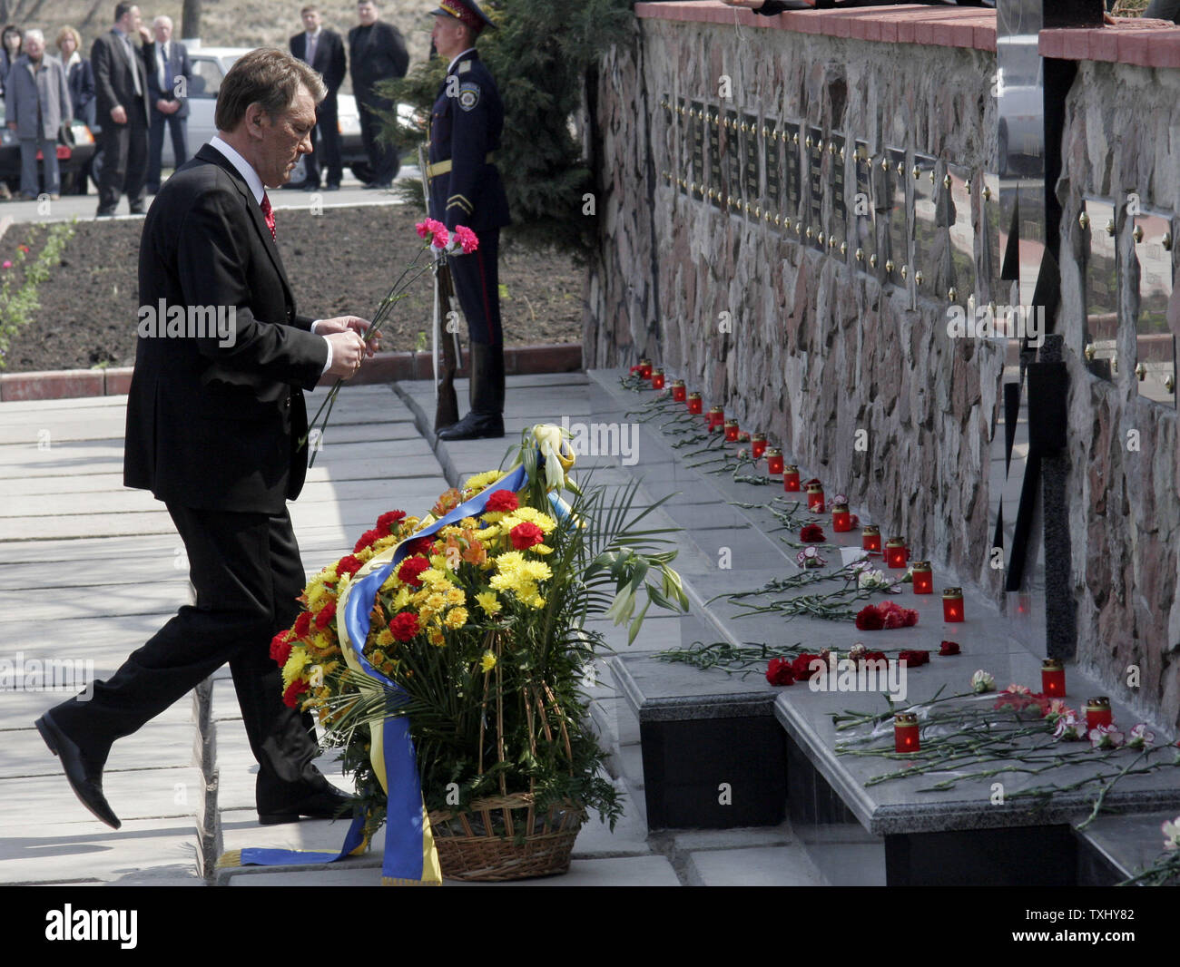 Ukrainian President Viktor Yushchenko lays flowers at a memorial monument of Chernobyl victims during the commemoration rally for those who died during and after  the Chernobyl nuclear disaster near the Chernobyl nuclear plant April 26, 2006. Today Ukraine marks the 20th anniversary of the Chernobyl nuclear disaster, when the fourth reactor at the Chernobyl plant exploded, spreading a radioactive cloud across the former Soviet Union. (UPI Photo/Sergey Starostenko) Stock Photo