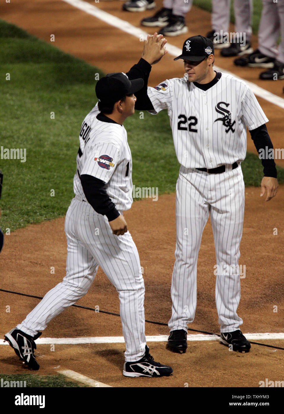 Chicago White Sox outfielder Scott Podsednik (22) center, is mobbed by  teammates after hitting the game winning home run in game 2 of the World  Series at U. S. Cellular Field, October