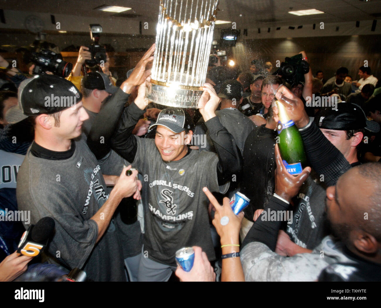 Chicago White Sox's Tadahito Iguchi, of Japan, hoists the World Series  trophy, as the White Sox celebrate their 1-0 over the Houston Astros in  game 4 of the World Series, October 26
