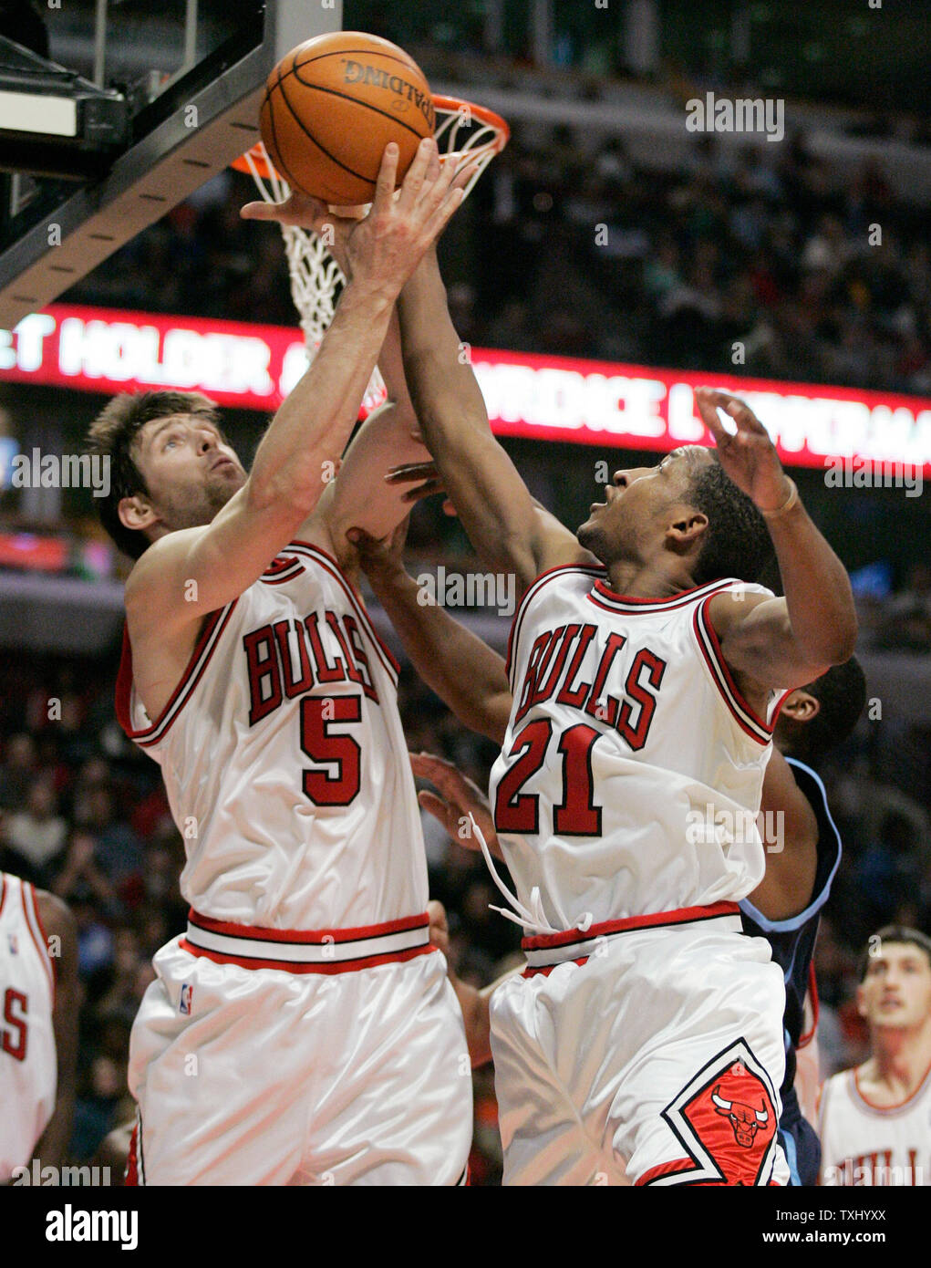 Chicago Bulls' Andres Nocioni (5), of Argentina, and Chris Duhon (21) go for a rebound during the fourth quarter against the Utah Jazz, November 12, 2005, in Chicago. The Bulls won 103-98. (UPI Photo/Brian Kersey) Stock Photo