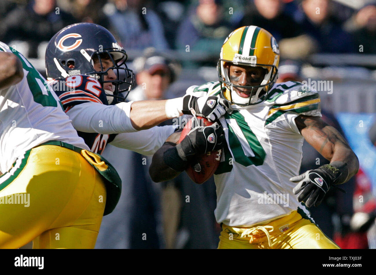 Chicago Bears linebacker Hunter Hillenmeyer (92) tackles Green Bay Packers receiver Donald Driver (80) after a reception during the first  quarter on December 4, 2005 at Soldier Field in Chicago. (UPI Photo/Brian Kersey) Stock Photo