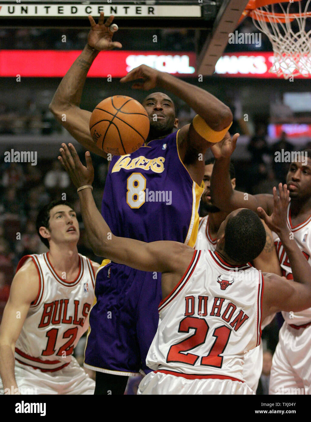 Los Angeles Lakers' Kobe Bryant (8) is fouled by Chicago Bulls' Chris Duhon (21) as he tries to go up for a shot past Duhon, Kirk Hinrich (12) and Michael Sweetney, right, during the first quarter on December 9, 2005, in Chicago. (UPI Photo/Brian Kersey) Stock Photo