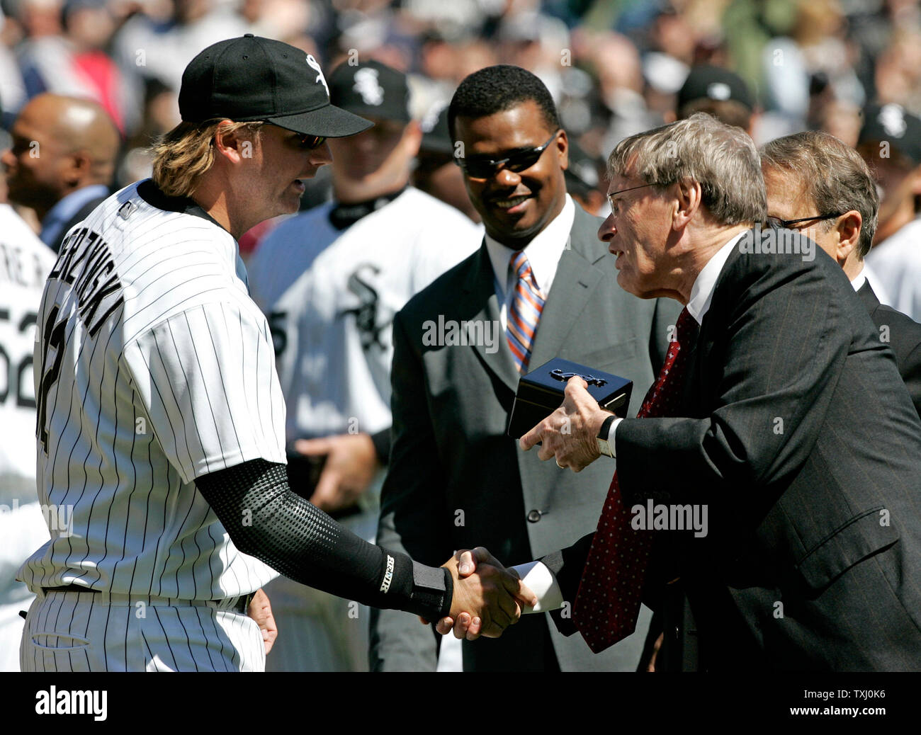 Chicago White Sox manager Ozzie Guillen, left, gets his 2005 World Series  Championship ring from chairman Jerry Reinsdorf before the game against the  Cleveland Indians on April 4, 2006, in Chicago. (UPI