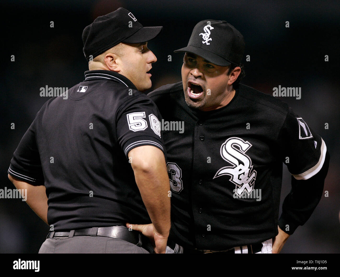 Chicago White Sox manager Ozzie Guillen, right, argues with first