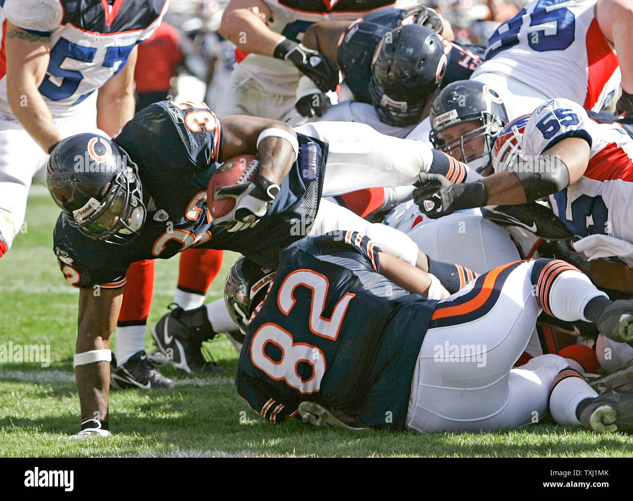 Chicago Bears running back Cedric Benson (32) jumps over the pile for a 1-yard run and his second touchdown of the game during the fourth quarter against the Buffalo Bills at Soldier Field in Chicago on October 8, 2006. The Bears won 40-7. (UPI Photo/Brian Kersey) Stock Photo