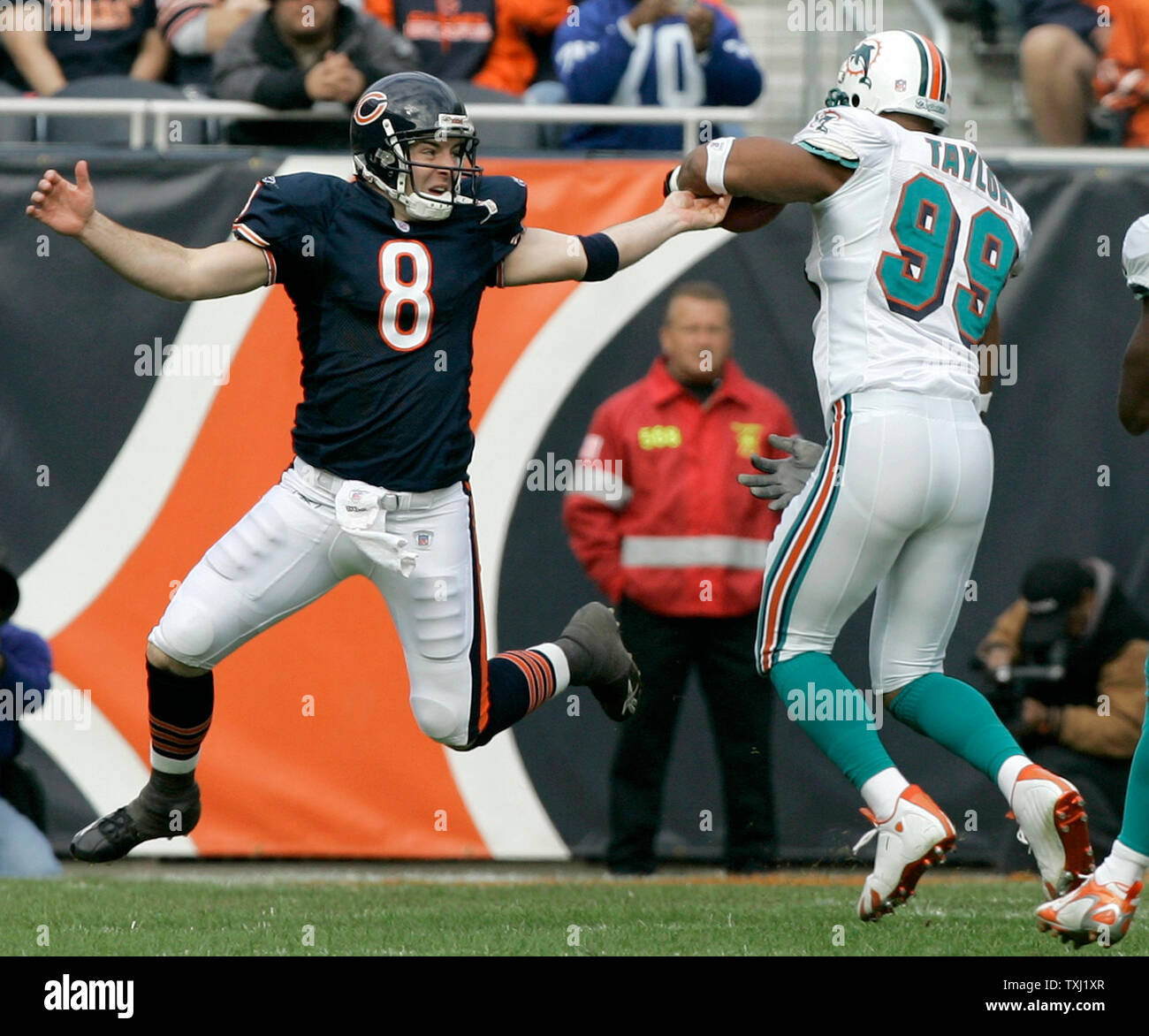 miami-dolphins-defensive-end-jason-taylor-99-eludes-chicago-bears-quarterback-rex-grossman-8-after-grossmans-pass-was-intercepted-by-taylor-during-the-second-quarter-at-soldier-field-in-chicago-on-november-5-2006-taylor-returned-the-interception-for-20-yards-and-a-touchdown-upi-photobrian-kersey-TXJ1XR.jpg