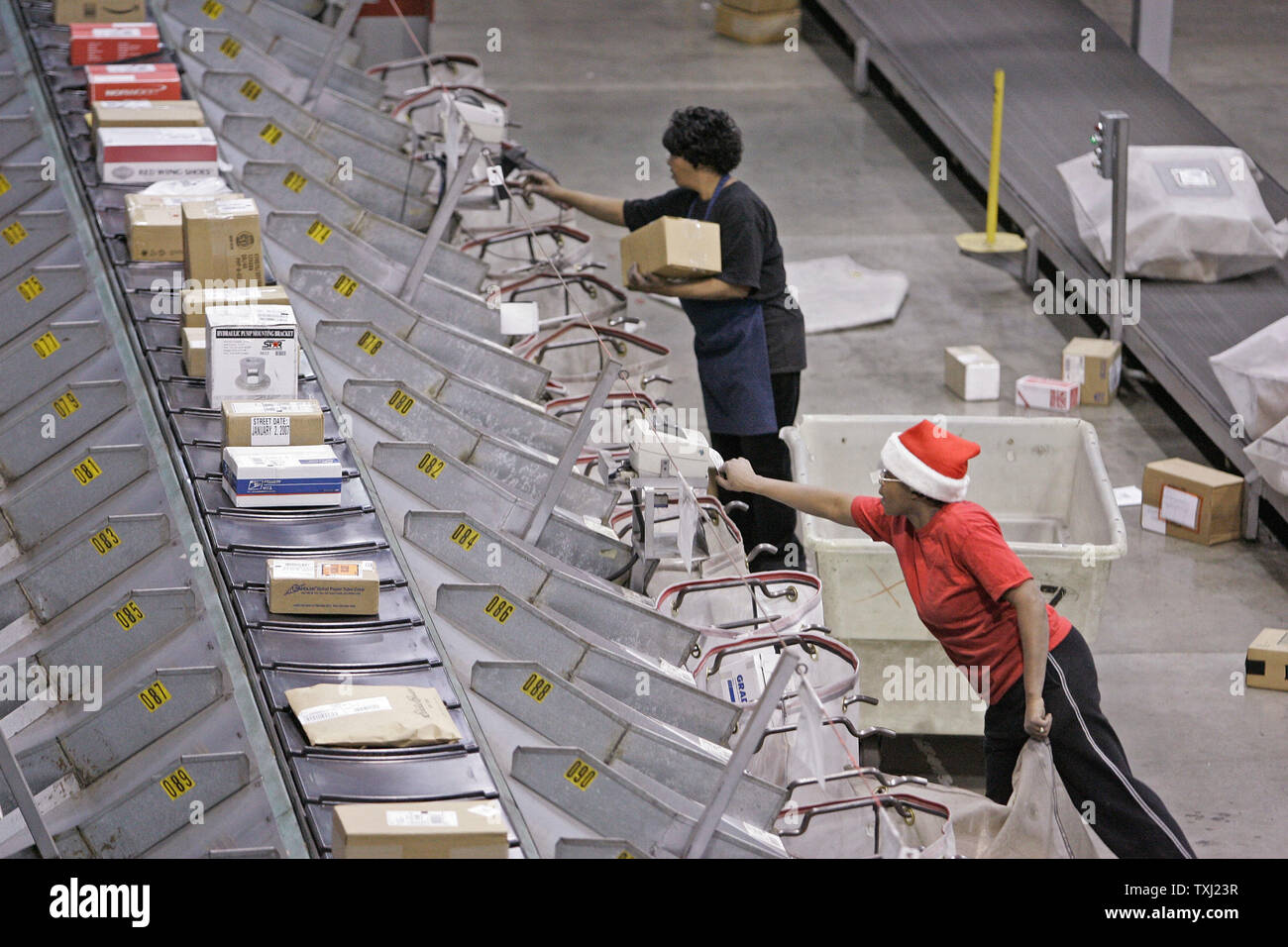Workers sort packages at UPS' Chicago Area Consolidation Hub in