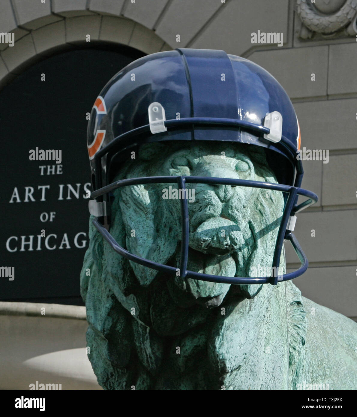 One of the two bronze lions wears a fiberglass Chicago Bears helmet at The Art Institute of Chicago on February 2, 2007, in Chicago. The lions were fitted with fiberglass helmets to celebrate the Bears winning season. The Bears play the Indianapolis Colts in Super Bowl XLI on Sunday. (UPI Photo/Brian Kersey) Stock Photo