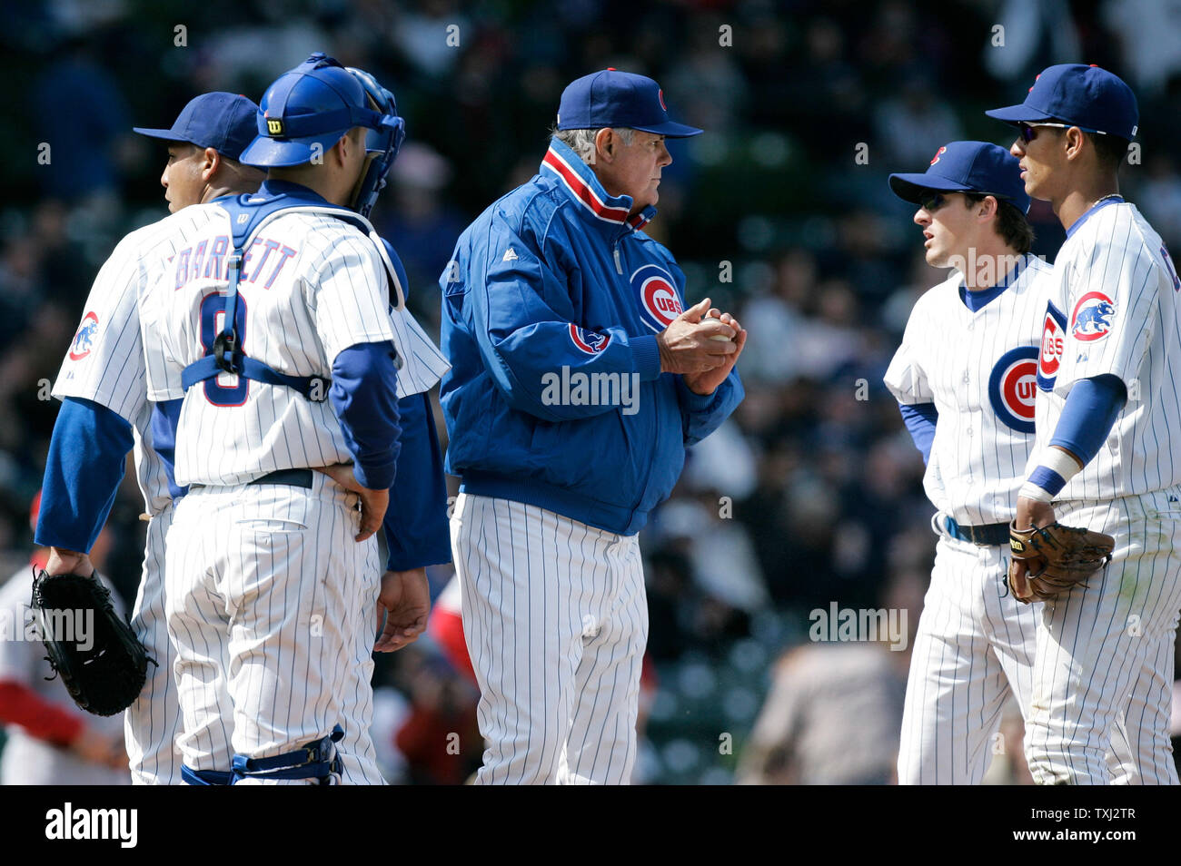 Chicago Cubs manager Lou Piniella (C) waits on the mound for a new