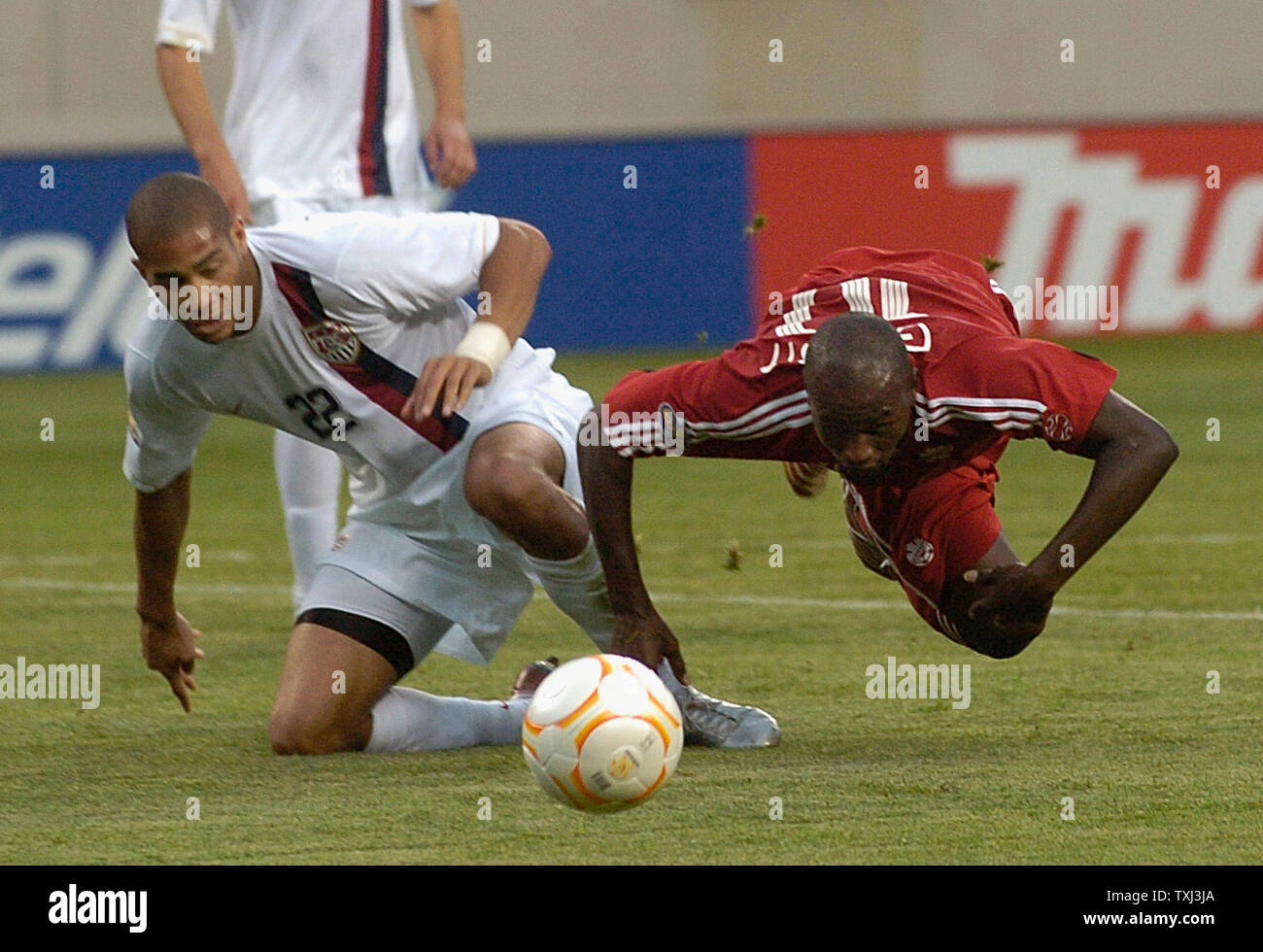 Canada's Ali Gerba (R) battles United States' Oguchi Onyewu (L) for the ball during the second half of the CONCACAF Gold Cup semifinal match at Soldier Field in Chicago on June 21, 2007. The United States won 2-1.  (UPI Photo/John Sommers II) Stock Photo