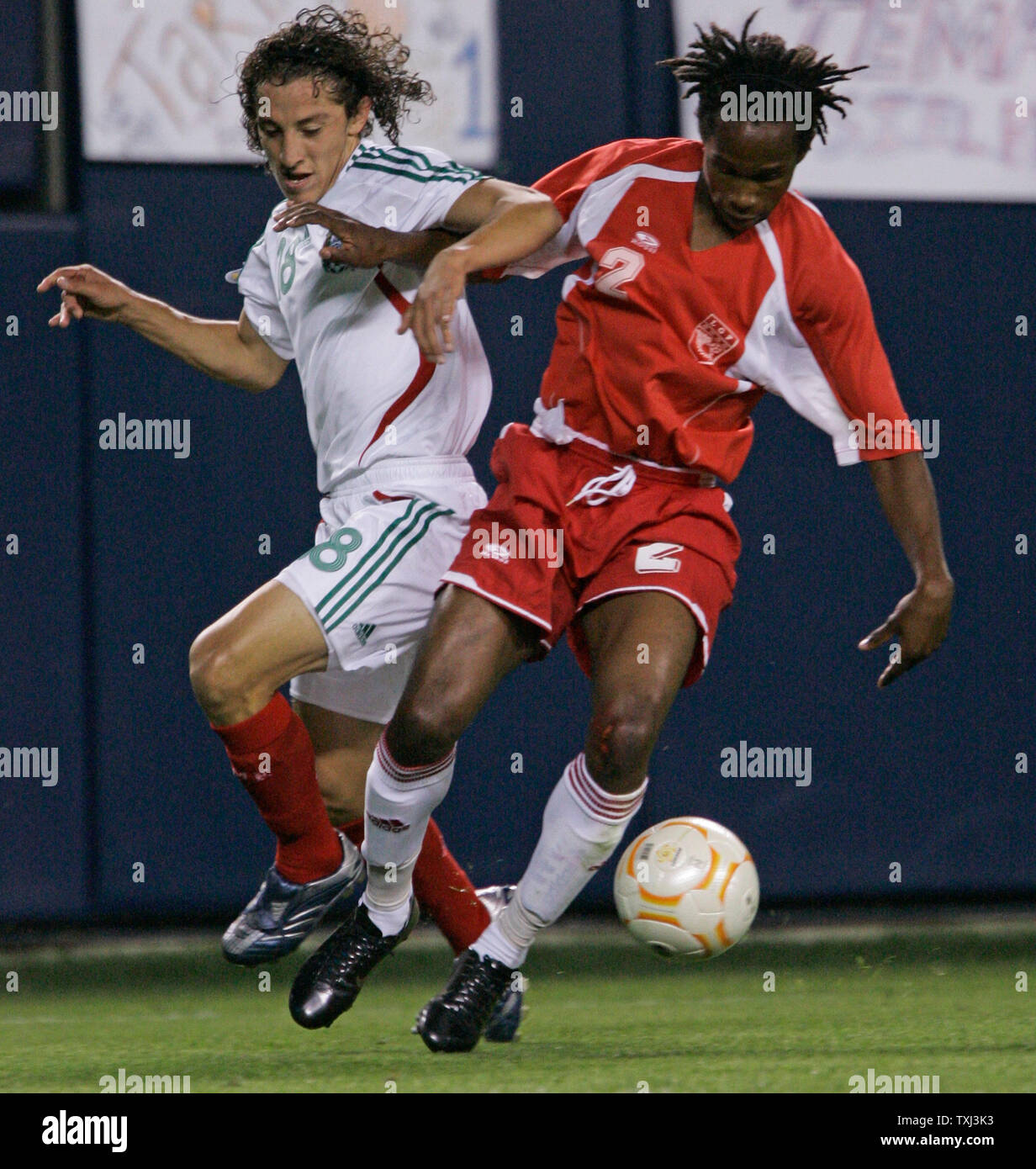 Mexico's Jose Andres Guardado (L) and Guadeloupe's Miguel Comminges (2) fight for the ball during the first half of the CONCACAF Gold Cup semifinal match at Soldier Field in Chicago on June 21, 2007. Mexico won 1-0. (UPI Photo/Brian Kersey) Stock Photo