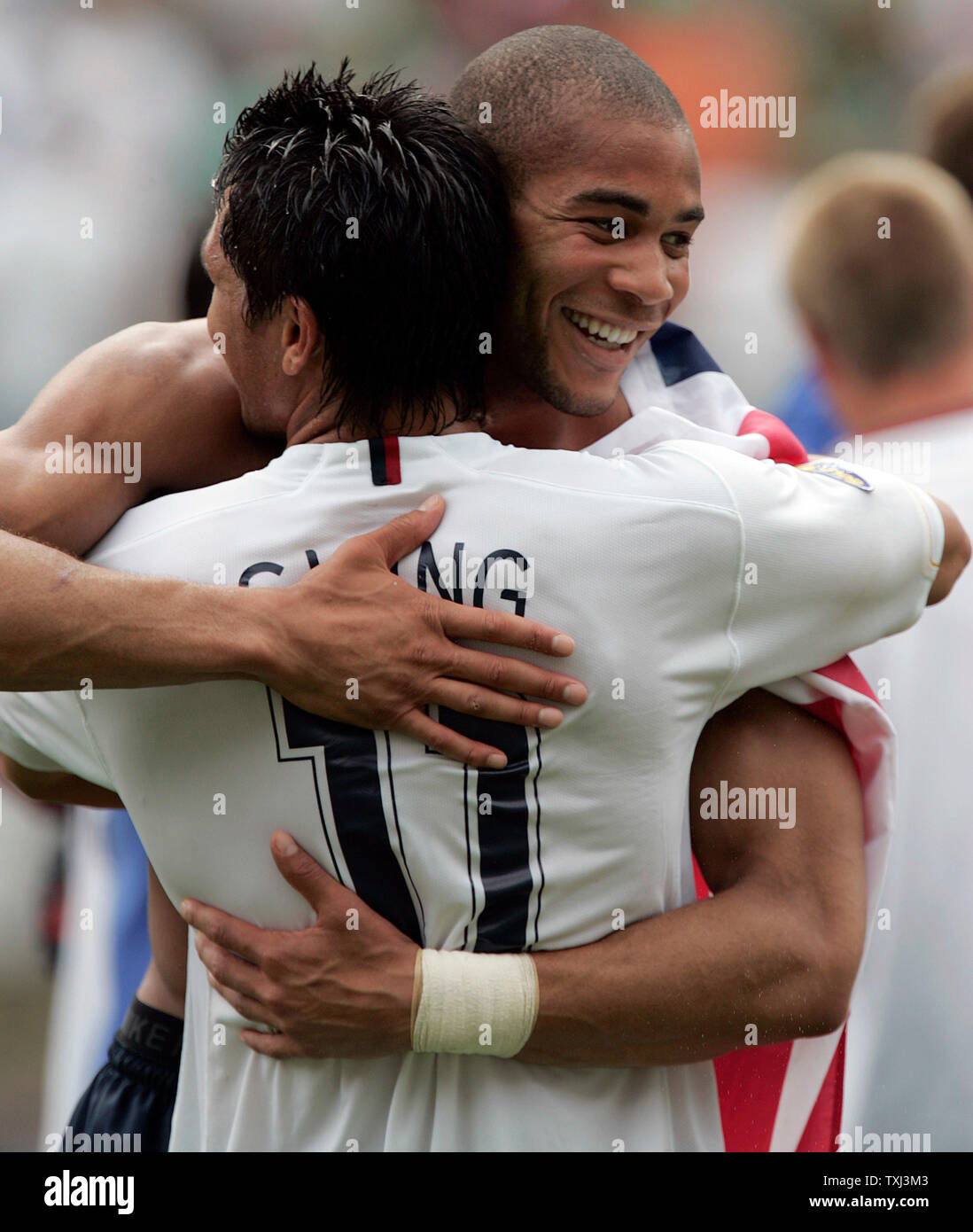 USA players Oguchi Onyewu (R) and Brian Ching (11) hug after defeating Mexico 2-1 to win the CONCACAF Gold Cup final match at Soldier Field in Chicago on June 24, 2007. (UPI Photo/Mark Cowan) Stock Photo