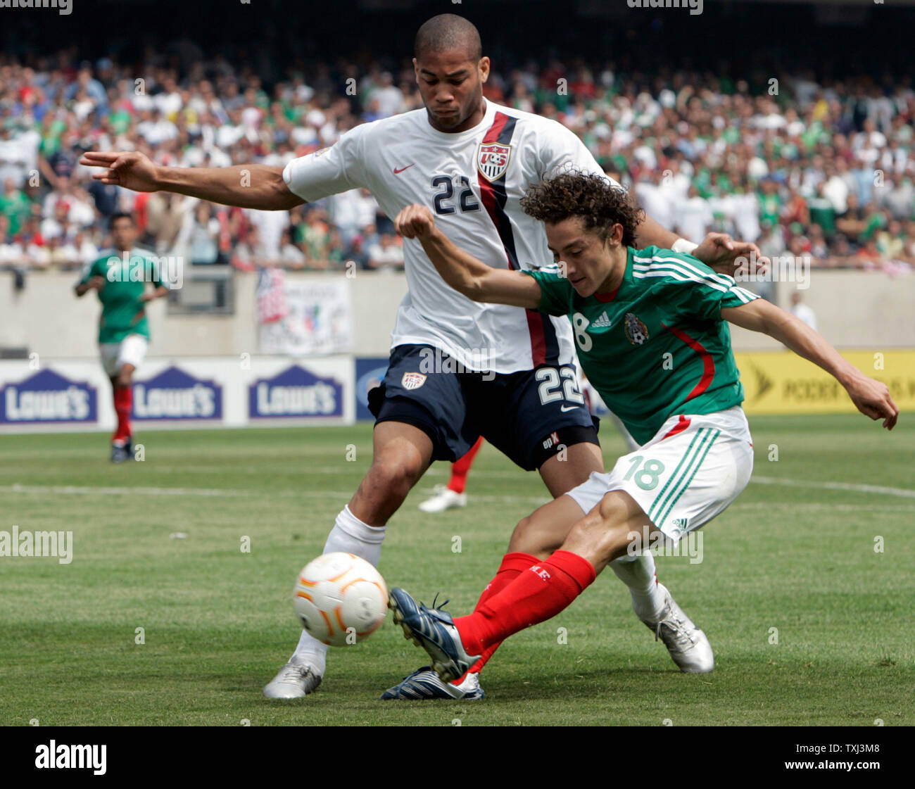 Mexico's Jose Andres Guardado (18) scores a goal in front of USA's Oguchi Onyewu (22) during the CONCACAF Gold Cup final match at Soldier Field in Chicago on June 24, 2007. (UPI Photo/Mark Cowan) Stock Photo