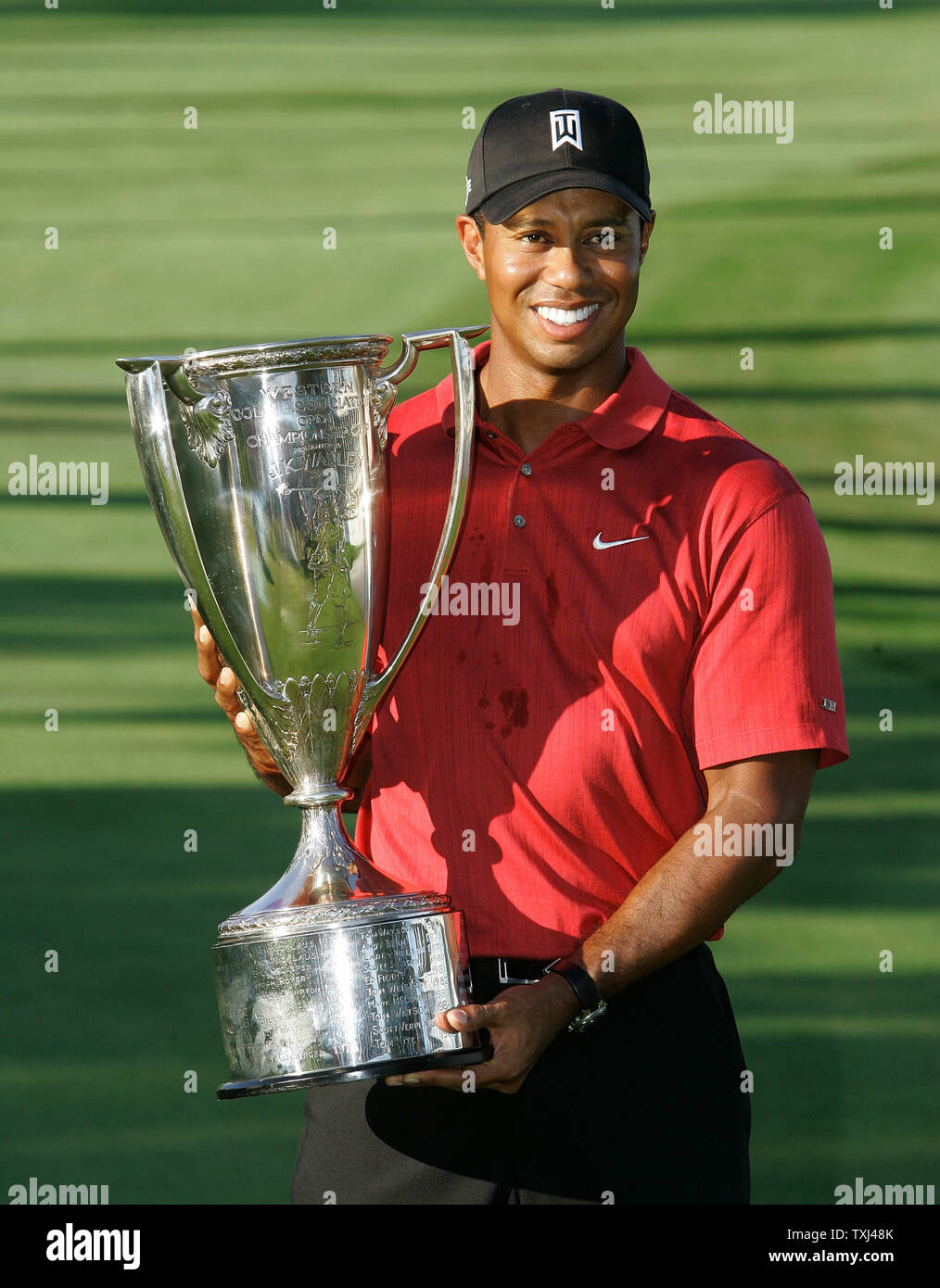 Tiger Woods holds the J. K. Wadley trophy after winning the BMW ...