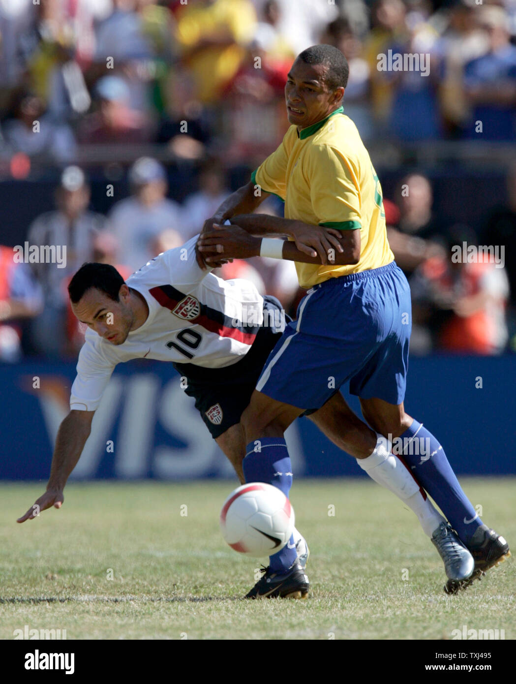 USA midfielder Landon Donovan (10) is tripped up by Brazil midfielder Gilberto Silva (8). Brazil defeated the USA 4-2 in their international friendly soccer match at Soldier Field in Chicago, September 9, 2007. (UPI Photo/Mark Cowan) Stock Photo