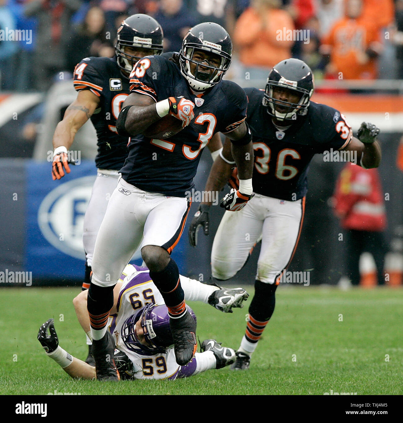 Chicago Bears punt returner Devin Hester (23) is helped up by