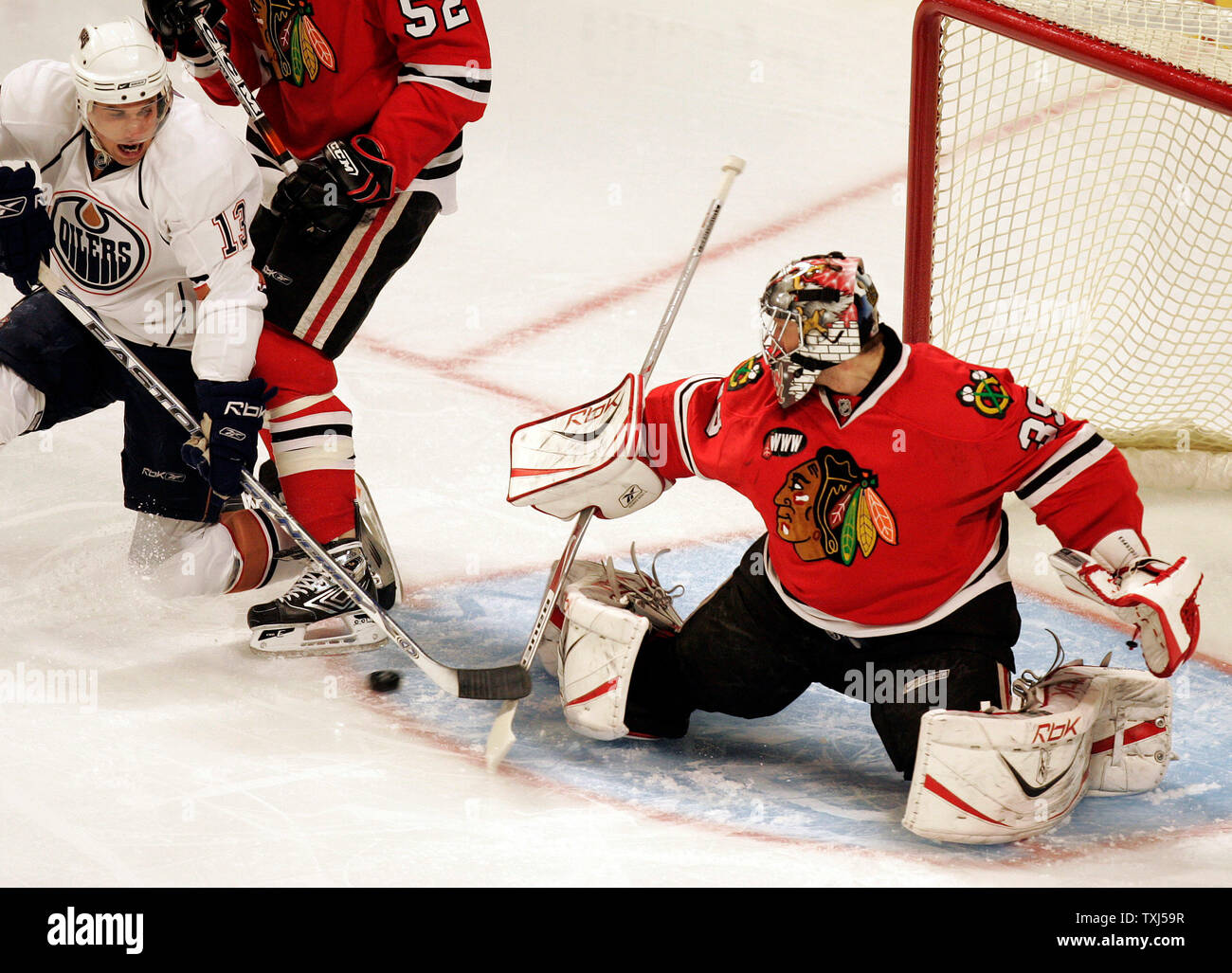 Chicago Blackhawks goaltender Nikolai Khabibulin clears ice from around the  goal after the St. Louis Blues score their third goal of the first period  at the Savvis Center in St. Louis on