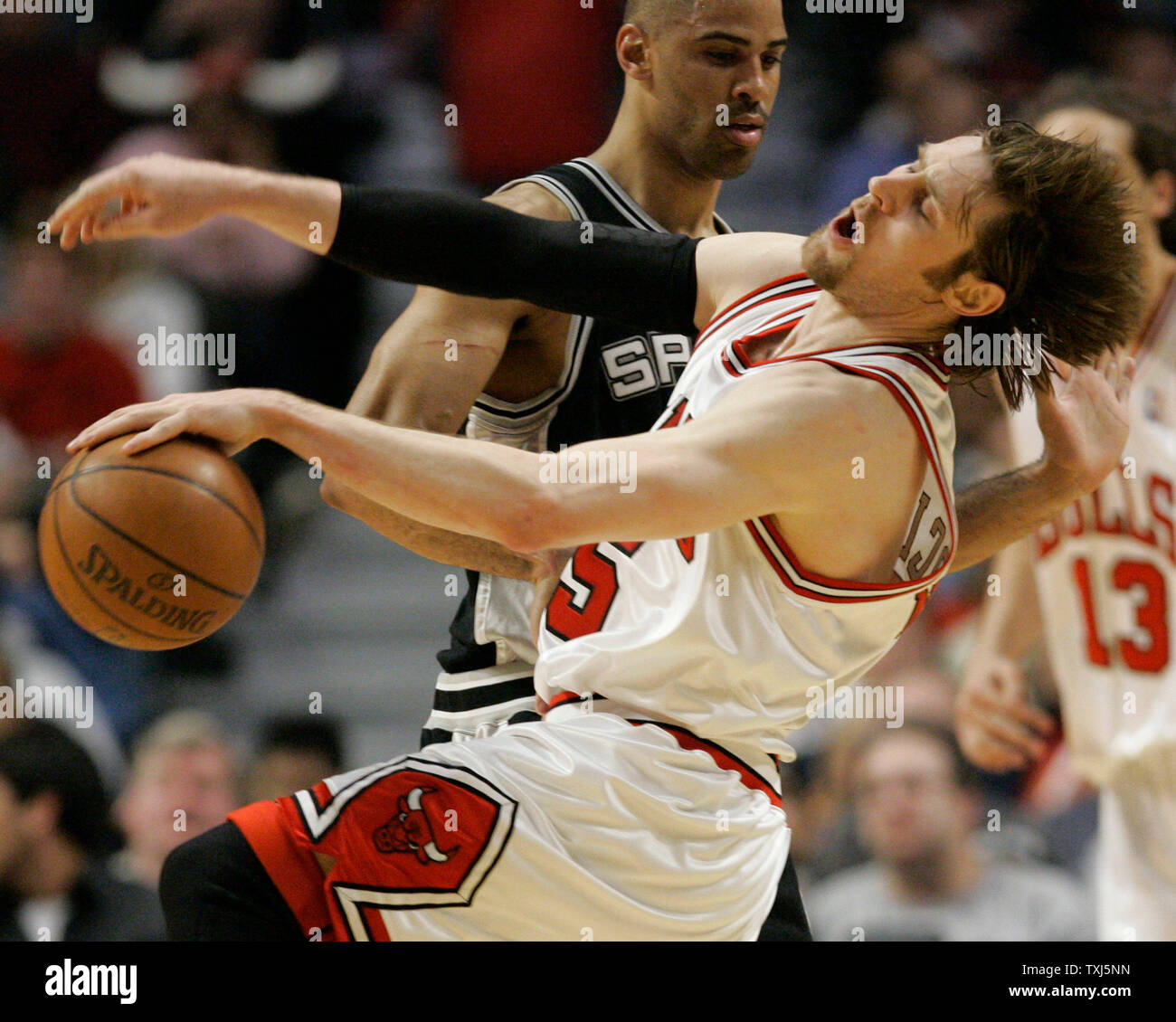 San Antonio Spurs Ime Udoka (L) fouls Chicago Bulls forward Andres Nocioni of Argentina during the fourth quarter in Chicago on March 20, 2008. The Spurs won 102-80. (UPI Photo/Brian Kersey) Stock Photo