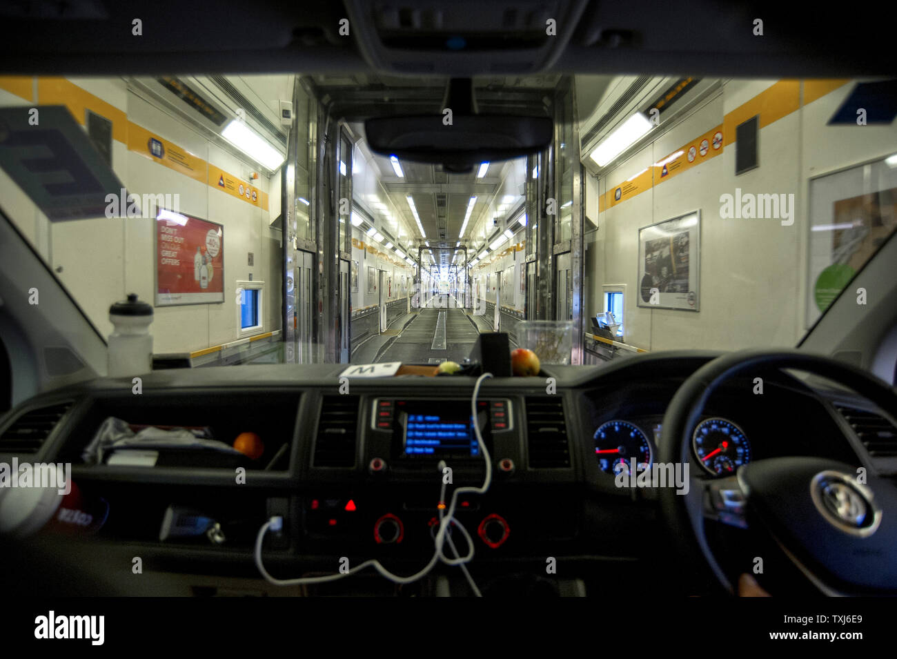 A van drives through a shuttle wagon, Eurotunnel Le Shuttle, Folkestone to Calais, Great Britain. Stock Photo