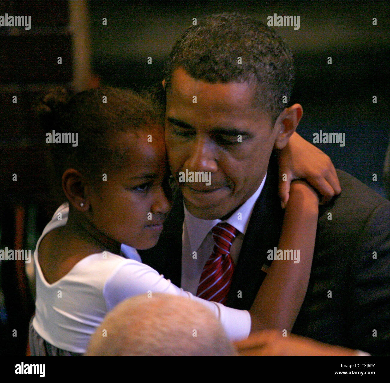 Democratic presidential hopeful Sen. Barack Obama (R) carries out his daughter Sasha, 7, after addressing congregants at the Apostolic Church of God in Chicago on June 15, 2008. Obama discussed the importance of fatherhood in his address to the church. (UPI Photo/Brian Kersey) Stock Photo