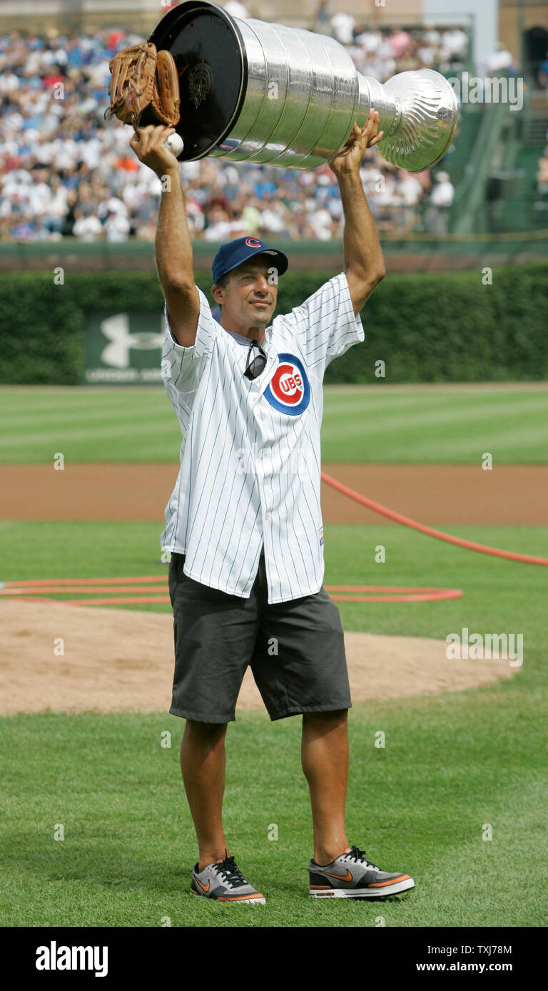 Detroit Red Wings defenseman and Chicago native Chris Chelios, hoists up  the Stanley Cup after throwing out the first pitch before the game against  the Washington Nationals at Wrigley Field in Chicago