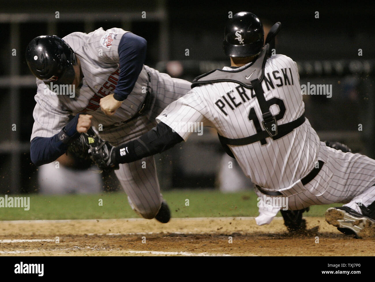 Chicago White Sox catcher A.J. Pierzynski (R) yells after tagging out  Minnesota Twins' Michael Cuddyer as he tried to tag up and score from third  base on a fly ball hit by