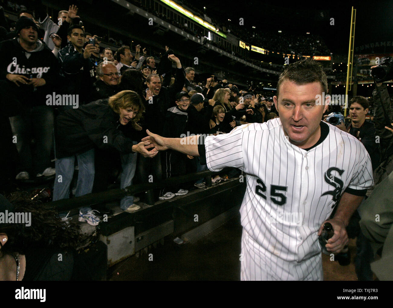 Chicago White Sox's Jim Thome, right, hugs his wife Andrea Thome after  defeating the Los Angeles Angels 9-7 in a baseball game on Sunday, Sept.  16, 2007, in Chicago. Thome hit a