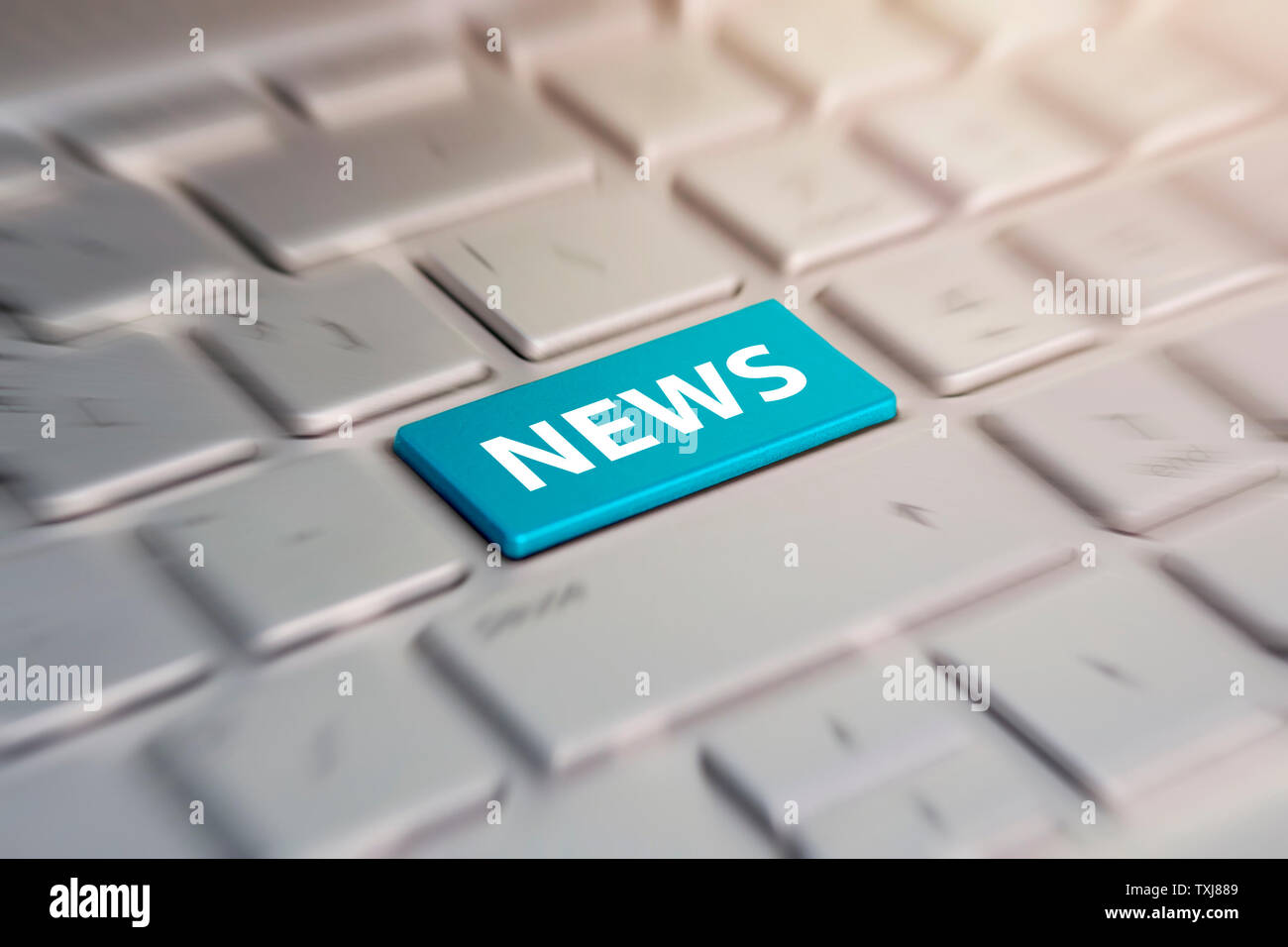 latest internet news concept with a blue button on computer keyboard. blue  button on grey silver laptop keyboard. blurred in motion background Stock  Photo - Alamy