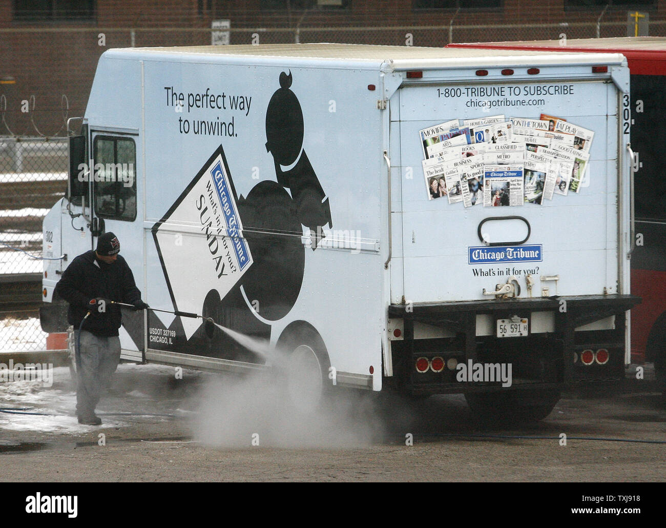 A worker washes a delivery truck at the Chicago Tribune's printing plant on December 8, 2008 in Chicago. The Tribune Company, which owns the Chicago Cubs baseball franchise, as well as the Los Angeles Times, Chicago Tribune, The Sun of Baltimore, The Hartford (Conn.) Courant, six other daily newspapers and 23 television stations, filed for bankruptcy protection Monday in a Delaware court.  (UPI Photo/Brian Kersey) Stock Photo