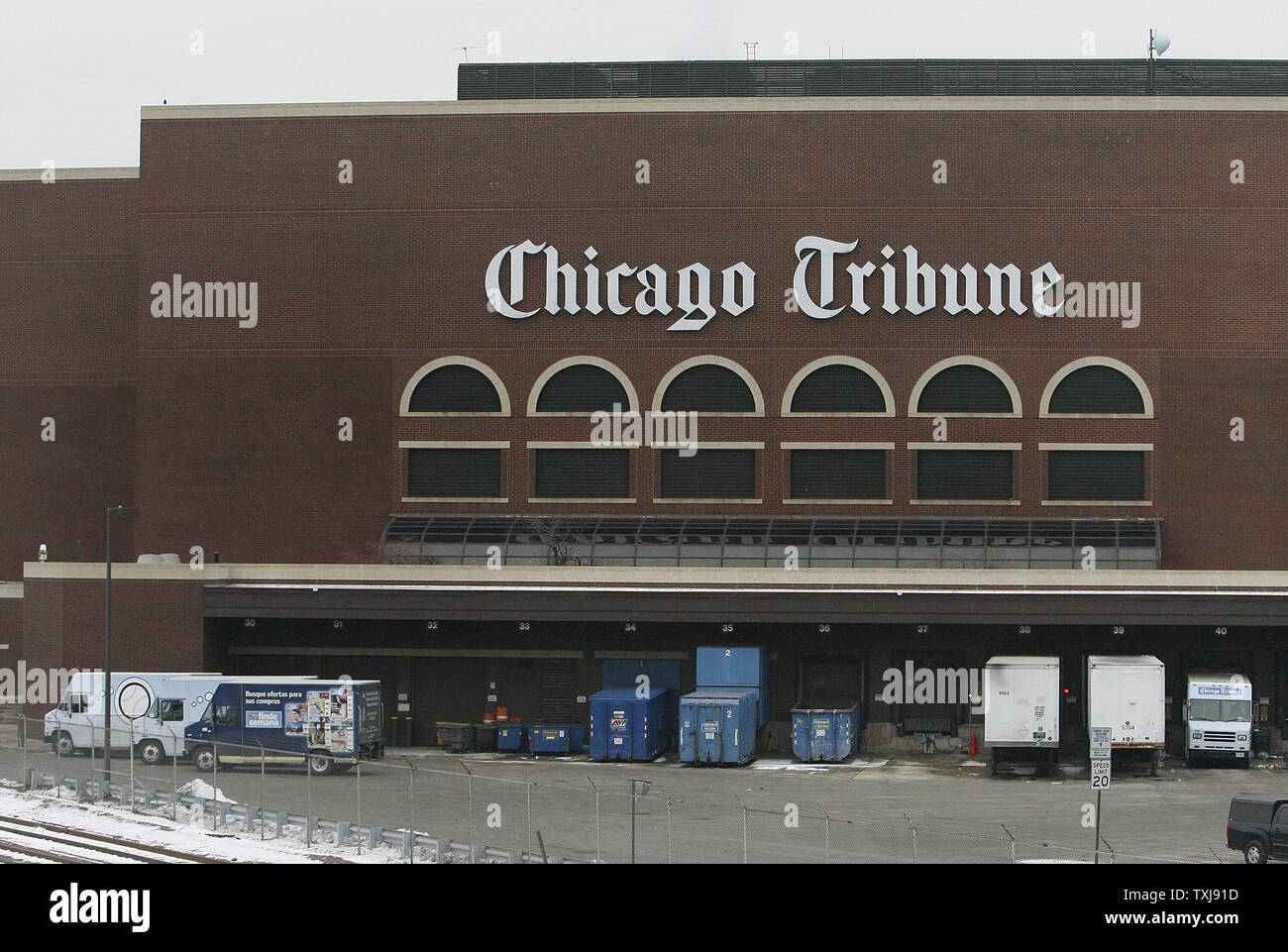 Trucks sit in a loading dock at the Chicago Tribune's printing plant on December 8, 2008 in Chicago. The Tribune Company, which owns the Chicago Cubs baseball franchise, as well as the Los Angeles Times, Chicago Tribune, The Sun of Baltimore, The Hartford (Conn.) Courant, six other daily newspapers and 23 television stations, filed for bankruptcy protection Monday in a Delaware court. (UPI Photo/Brian Kersey) Stock Photo