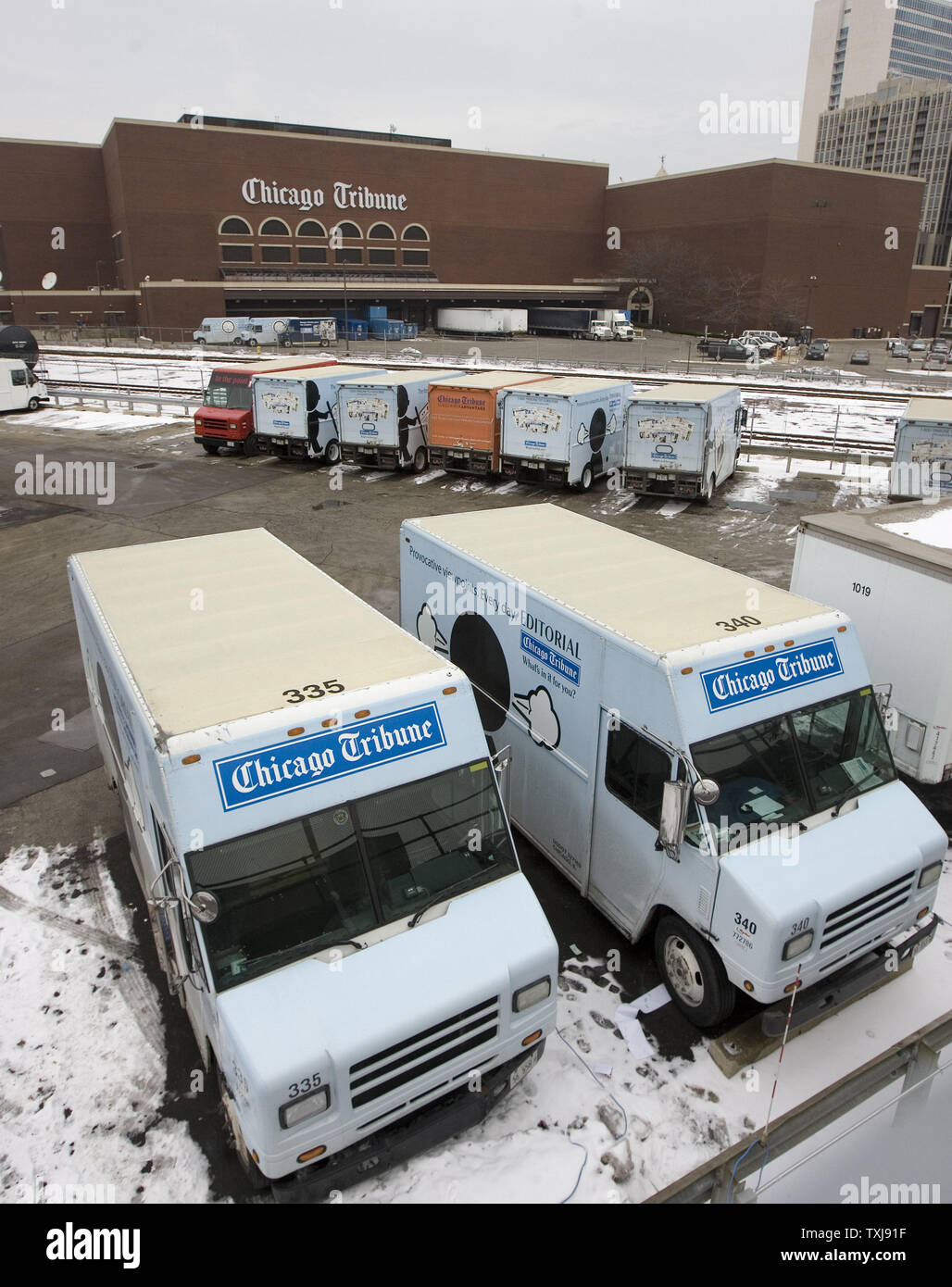 Delivery trucks sit parked in a lot in front of the Chicago Tribune's printing plant on December 8, 2008 in Chicago. The Tribune Company, which owns the Chicago Cubs baseball franchise, as well as the Los Angeles Times, Chicago Tribune, The Sun of Baltimore, The Hartford (Conn.) Courant, six other daily newspapers and 23 television stations, filed for bankruptcy protection Monday in a Delaware court. (UPI Photo/Brian Kersey) Stock Photo