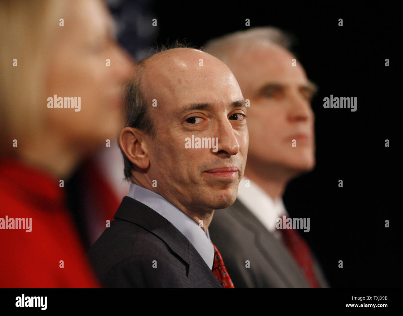 Gary Gensler (C), the new head of the Commodity Futures Trading Commission, stands with Mary Schapiro (L), the new head the of the Securities and Exchange Commission, and Daniel Tarullo, a new member of the Federal Reserve board, during a news conference at which President-elect Barack Obama introduced the three on December 18, 2008 in Chicago.  By appointing these non-cabinet positions at this early date, Obama stressed the importance of reforming regulations governing Wall Street to prevent future economic crises. (UPI Photo/Brian Kersey) Stock Photo