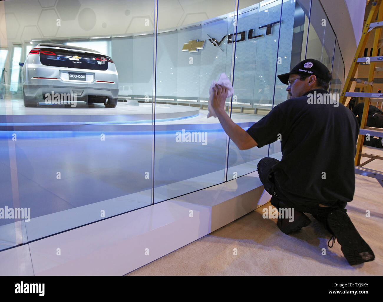 Thomas Barnes Cleans A Display For The Chevy Volt At The 2009
