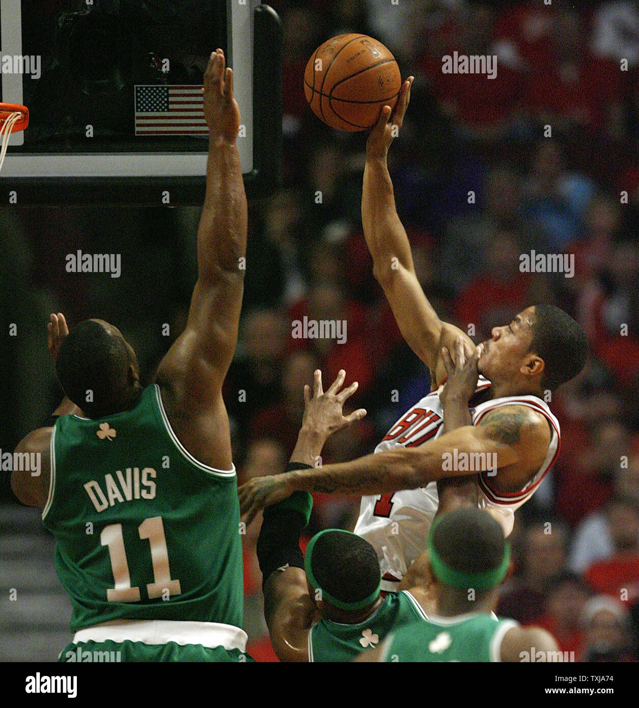 Chicago Bulls' Derrick Rose (L) goes up for a shot as Boston Celtics'  Glen Davis defends during the first quarter of game 3 of their NBA Eastern Conference Quarterfinal at the United Center in Chicago on April 23, 2009. (UPI Photo/Brian Kersey) Stock Photo