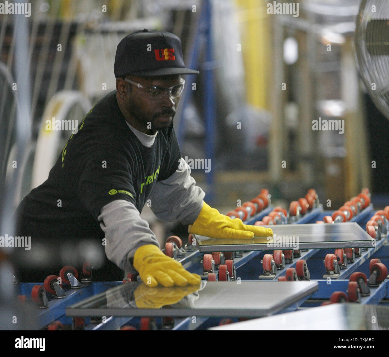 A Worker Handles Glass At The Serious Materials Window Factory In