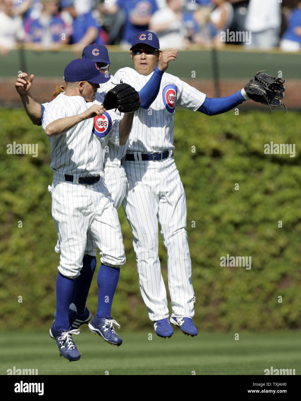 Chicago Cubs outfielders Ryan Freel, left, Reed Johnson, center, and Kosuke Fukudome, right, from Japan celebrate the Cubs 11-3 win over the San Diego Padres at Wrigley Field in Chicago on May 14, 2009. (UPI Photo/Mark Cowan) Stock Photo