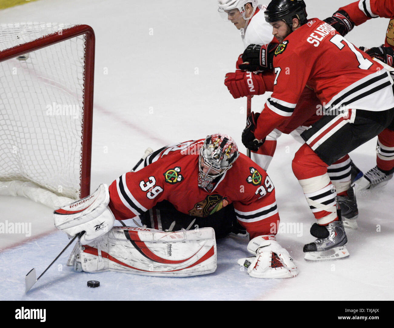 Chicago Blackhawks goalie Nikolai Khabibulin, from Russia, reaches for the  puck as it slides through the crease during first period NHL hockey action  against the Calgary Flames in Calgary, Alberta, Thursday, Nov.