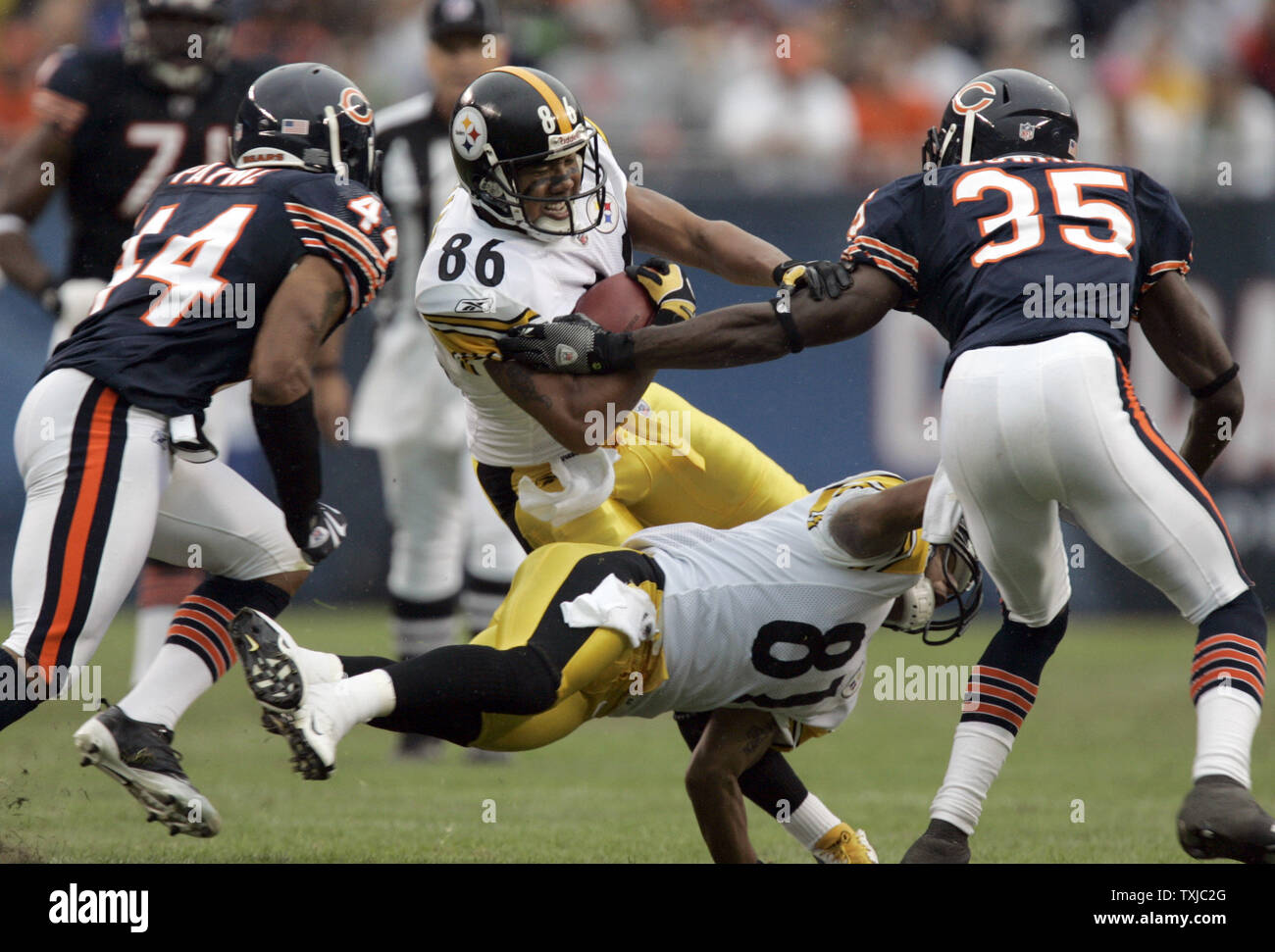 Pittsburgh Steelers wide receiver Hines Ward (86) gets a block from teammate Shaun McDonald (81) as Chicago Bears defenders Kevin Payne (44) and Zackary Bowman (35) bring him down in the second quarter at Soldier Field in Chicago on September 20, 2009. UPI /Mark Cowan Stock Photo