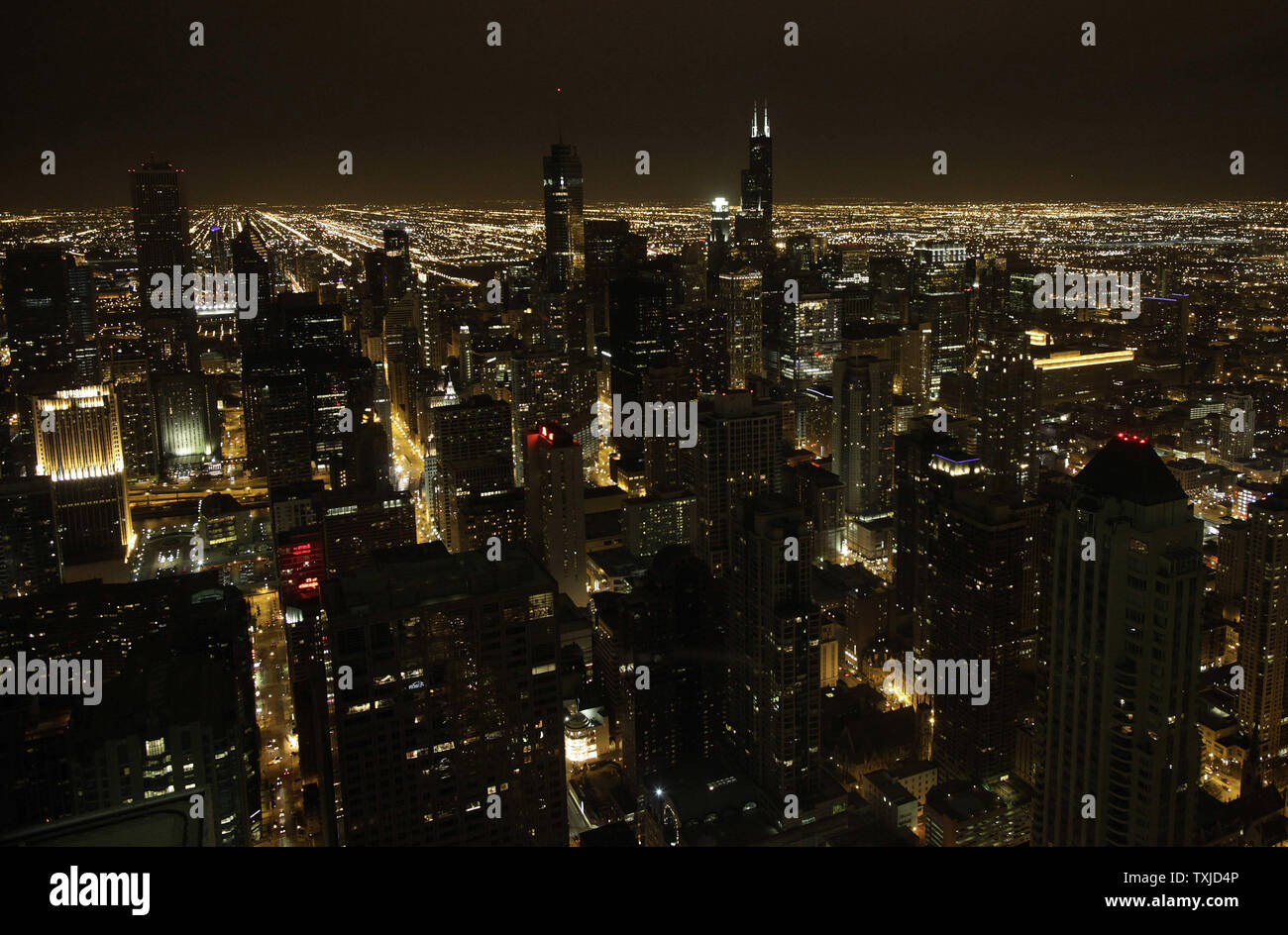 The Chicago skyline is seen from the John Hancock Center 94th floor observatory prior to the start of Earth Hour in Chicago on March 27, 2010. Chicago residents and businesses joined an estimated one billion people in 121 countries who are expected to take part in Earth Hour, a time set aside on Saturday to turn off unnecessary lights for one hour to raise awareness about energy conservation.     UPI/Brian Kersey Stock Photo