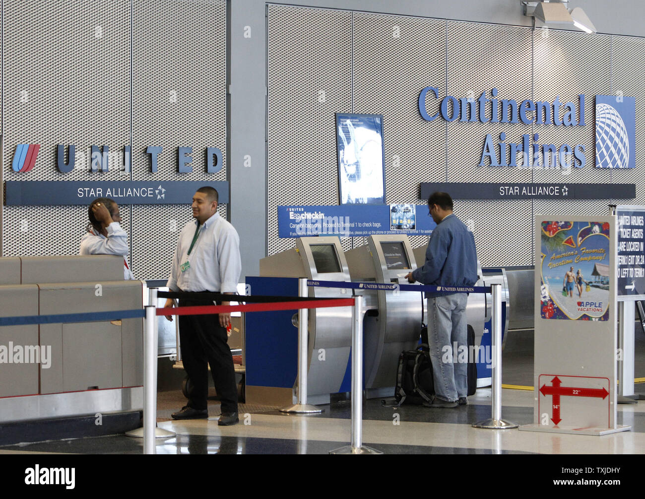 A Passenger Checks In At A United Airlines Ticket Counter As A