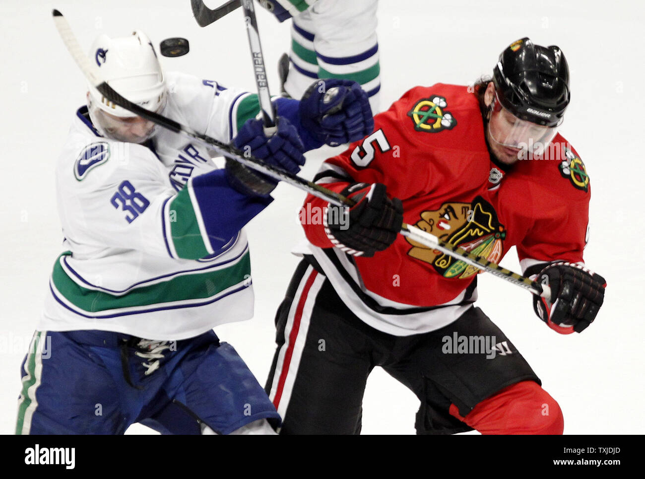 Vancouver Canucks right wing Pavol Demitra (L) and Chicago Blackhawks defenseman Brent Sopel go for the puck during the first period of game 2 of the NHL Western Conference semifinals at the United Center in Chicago on May 3, 2010.     UPI/Brian Kersey Stock Photo