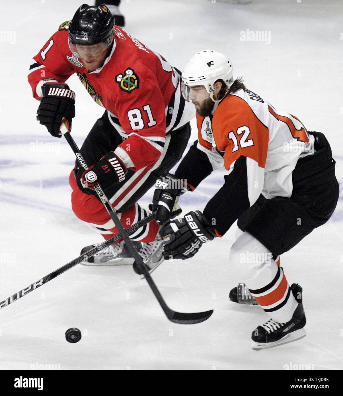 Philadelphia Flyers left wing Simon Gagne (12) and Chicago Blackhawks right wing Marian Hossa (81) battle for a loose puck during the first period of game 5 of the 2010 Stanley Cup Final at the United Center in Chicago, June 6, 2010. (UPI Photo/Mark Cowan) Stock Photo