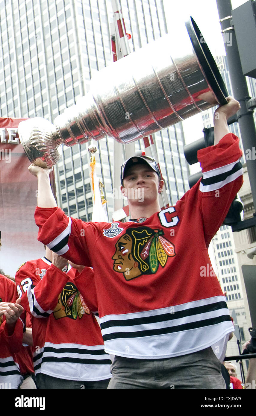 Jonathan Toews team captain for the Chicago Blackhawks holds up the Stanley  Cup as he enters the stage during a rally as the Chicago Blackhawks  celebrate in Chicago on June 11, 2010.