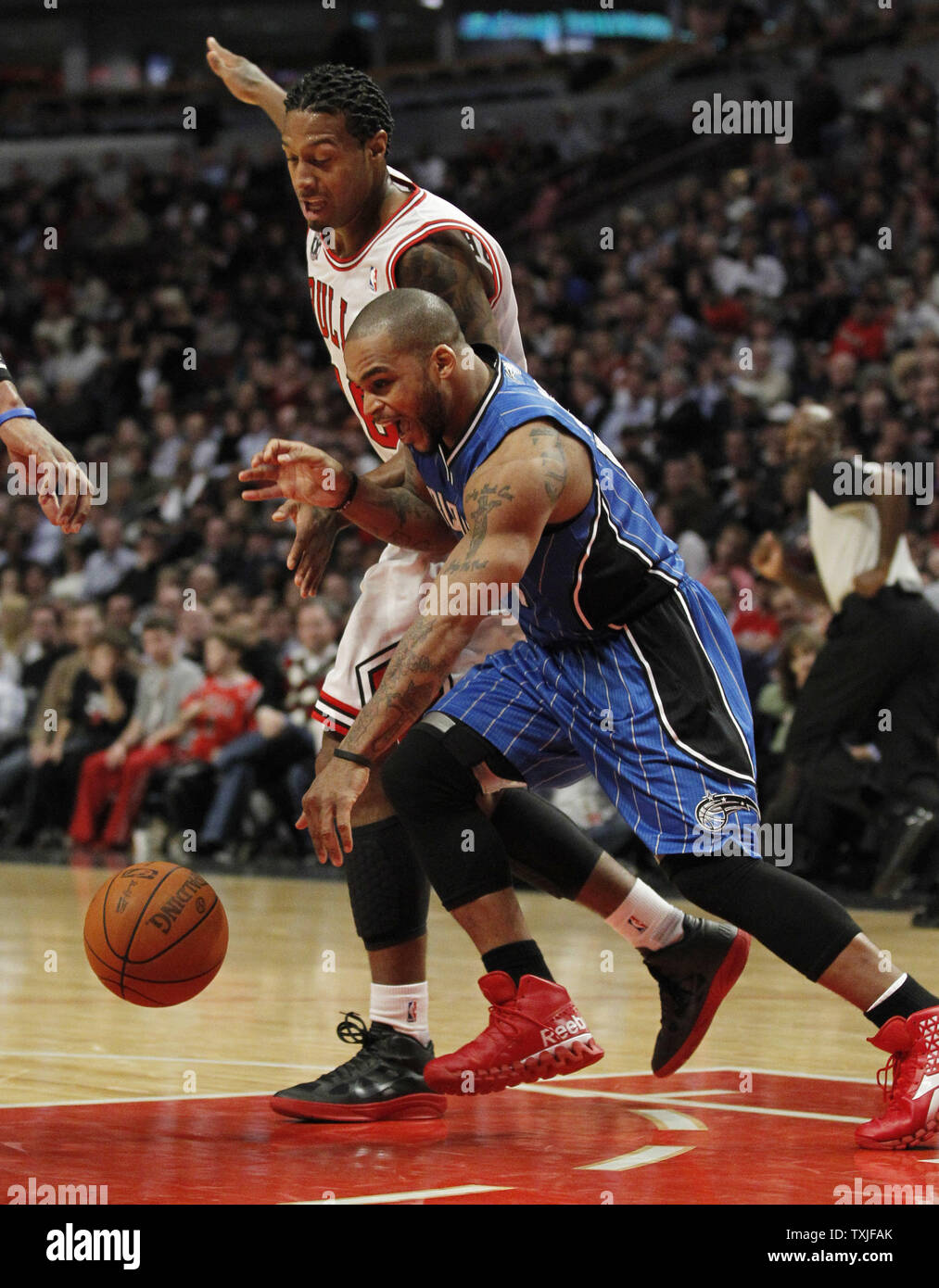 Orlando Magic guard Jameer Nelson (R) and Chicago Bulls forward James Johnson go for a loose ball during the fourth quarter at the United Center in Chicago on December 1, 2010. The Magic won 107-78.     UPI/Brian Kersey Stock Photo