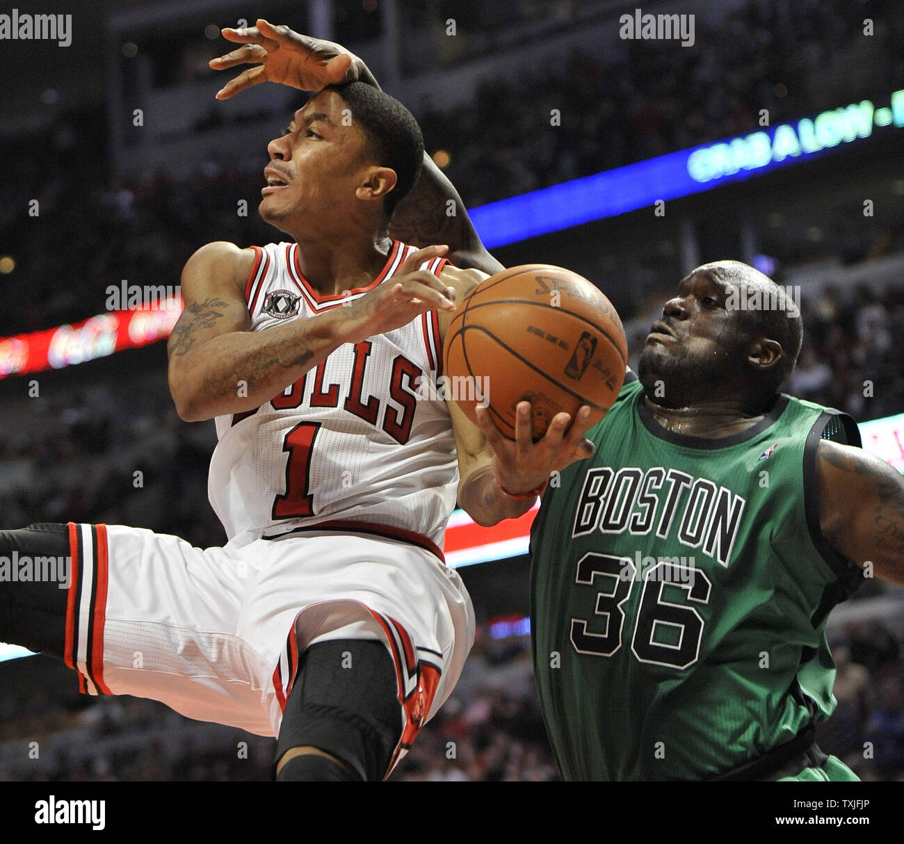 Boston Celtics center Shaquille O Neal R fouls Chicago Bulls guard Derrick Rose as he drives to the basket during the third quarter at the United Center in Chicago on January 8 2011