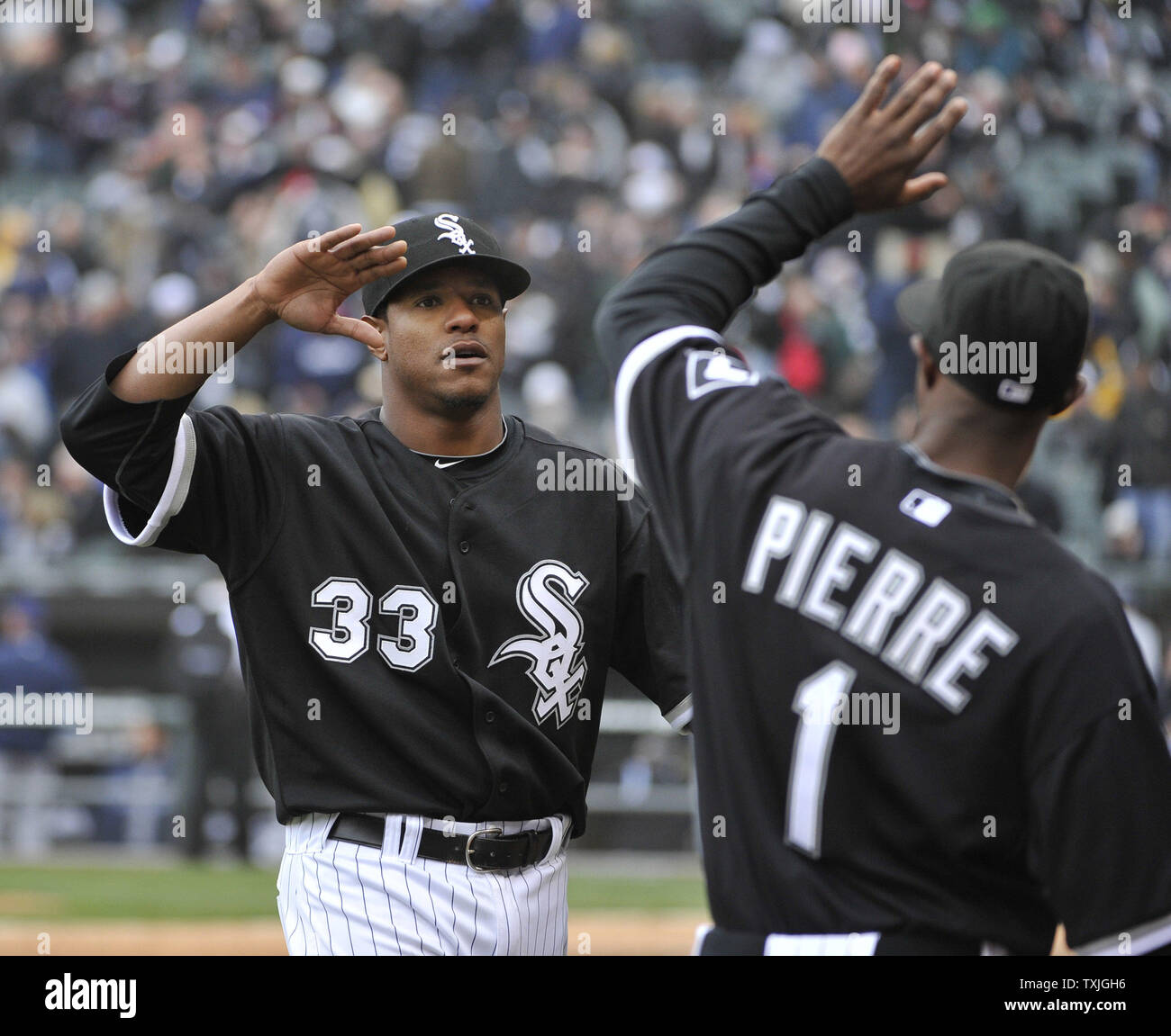 Chicago White Sox starting pitcher Edwin Jackson (L) gets a high-five from left fielder Juan Pierre after finishing the seventh inning of their home opener against the Tampa Bay Rays at U.S. Cellular Field in Chicago on April 7, 2011. The White Sox won 5-1.     UPI/Brian Kersey Stock Photo