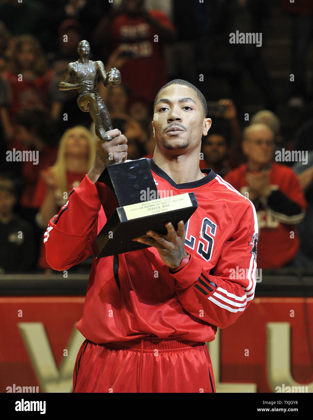 Chicago Bulls guard Derrick Rose holds up the Maurice Podoloff Trophy after  being named the NBA MVP at a ceremony before game 2 of the NBA Eastern  Conference Semifinals against the Atlanta