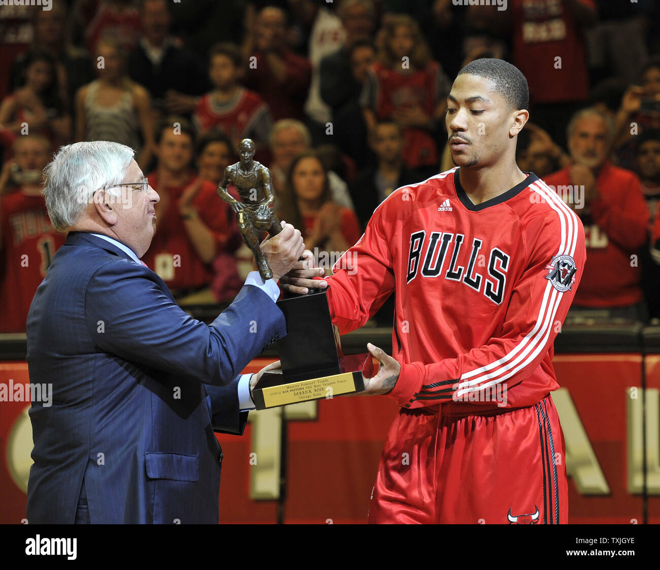 Chicago Bulls guard Derrick Rose (R) is presented the Maurice Podoloff  Trophy by NBA Commissioner David Stern after being named the NBA MVP at a  ceremony before game 2 of the NBA